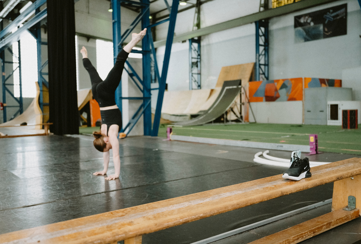 Acrobat training handstands at a circus studio