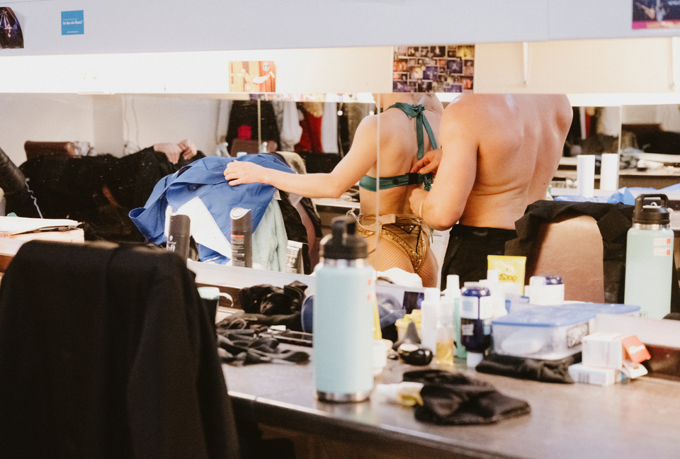 Circus performers putting on costumes before a show - backstage show prep