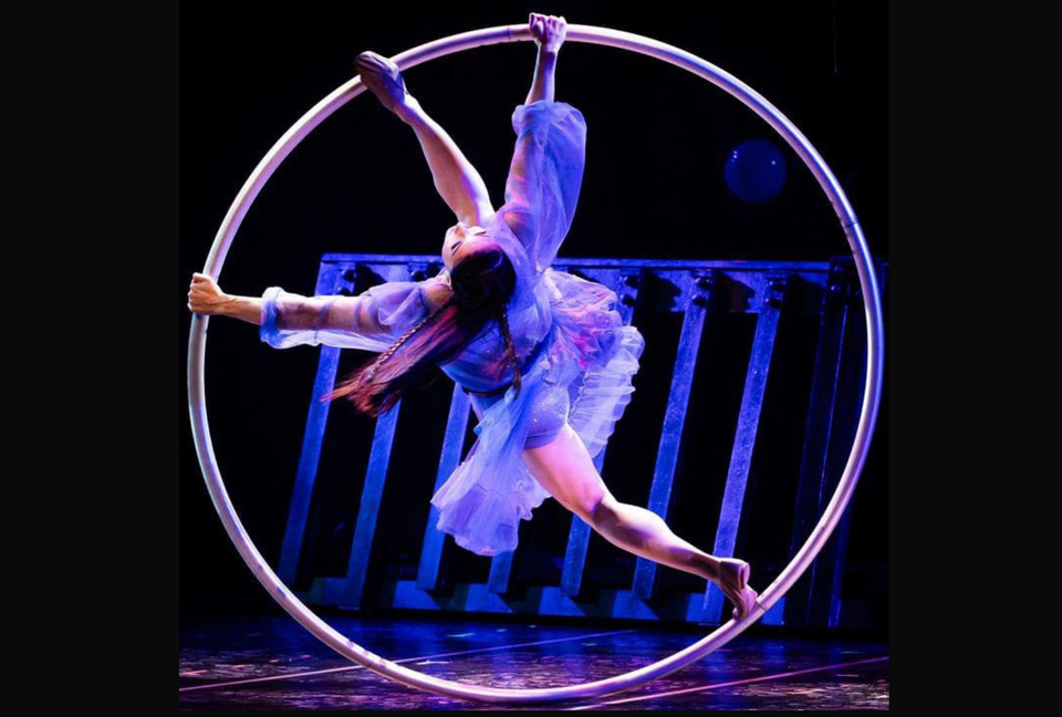 Female cyr wheel artist performing on stage for Cirque Du Soleil