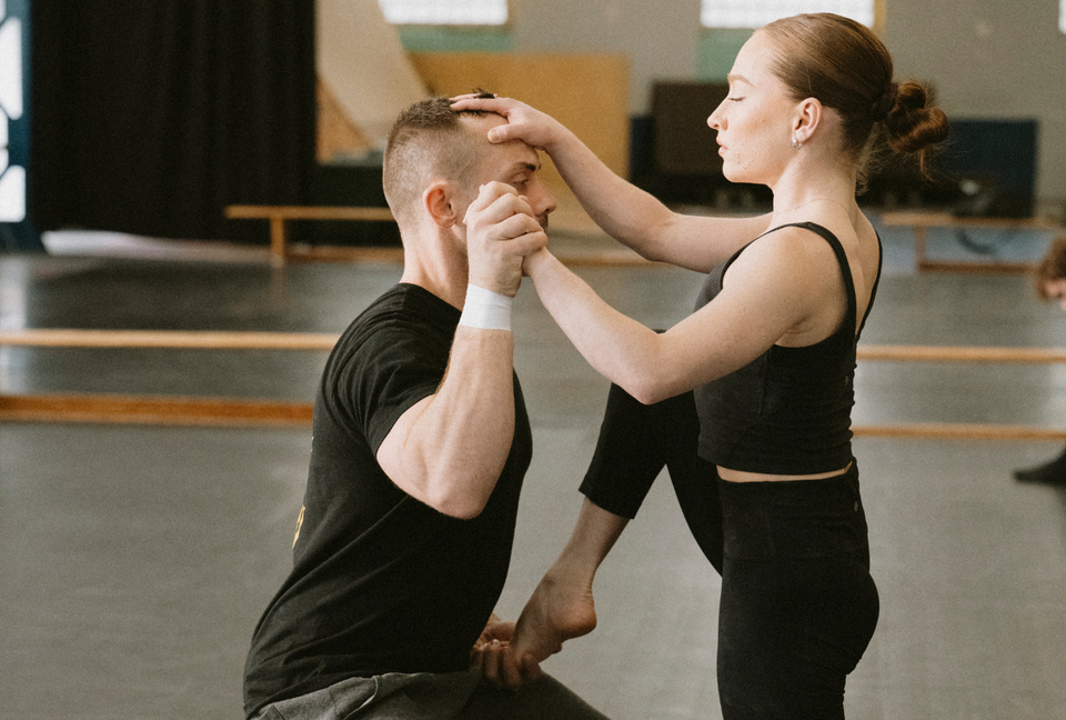 Circus duo training at a circus centre - one arm on head handstand - hand grip on head
