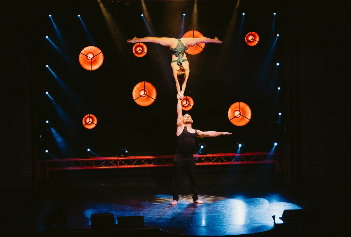 Circus duo performing a one arm handstand on stage - grip by AcroGrip liquid chalk