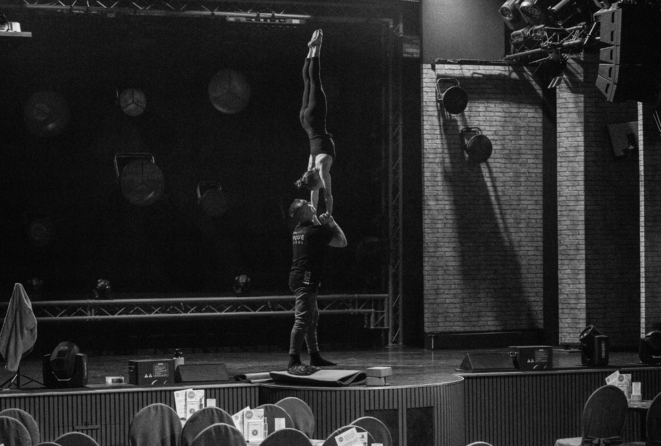 Hand to hand duo warming up on stage for a show - handstand grip by AcroGrip liquid chalk