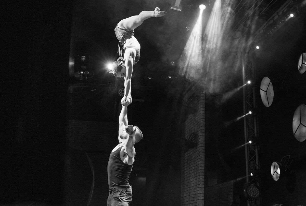 Circus duo performing a one arm handstand on stage - grip by AcroGrip liquid chalk