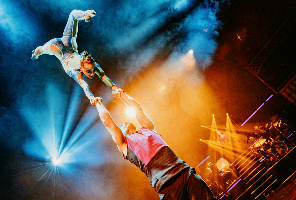 Circus duo performing a handstand on stage - grip by AcroGrip liquid chalk
