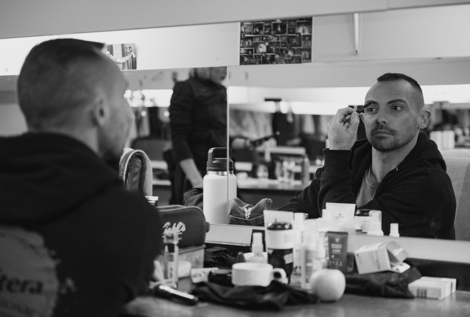 Circus artist backstage applying make up - getting ready for a show