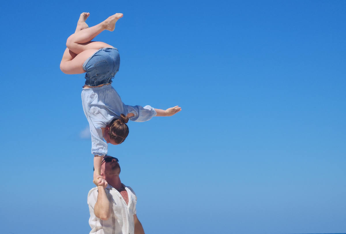 Outdoor photoshoot with a hand to hand duo - one arm handstand with AcroGrip liquid chalk